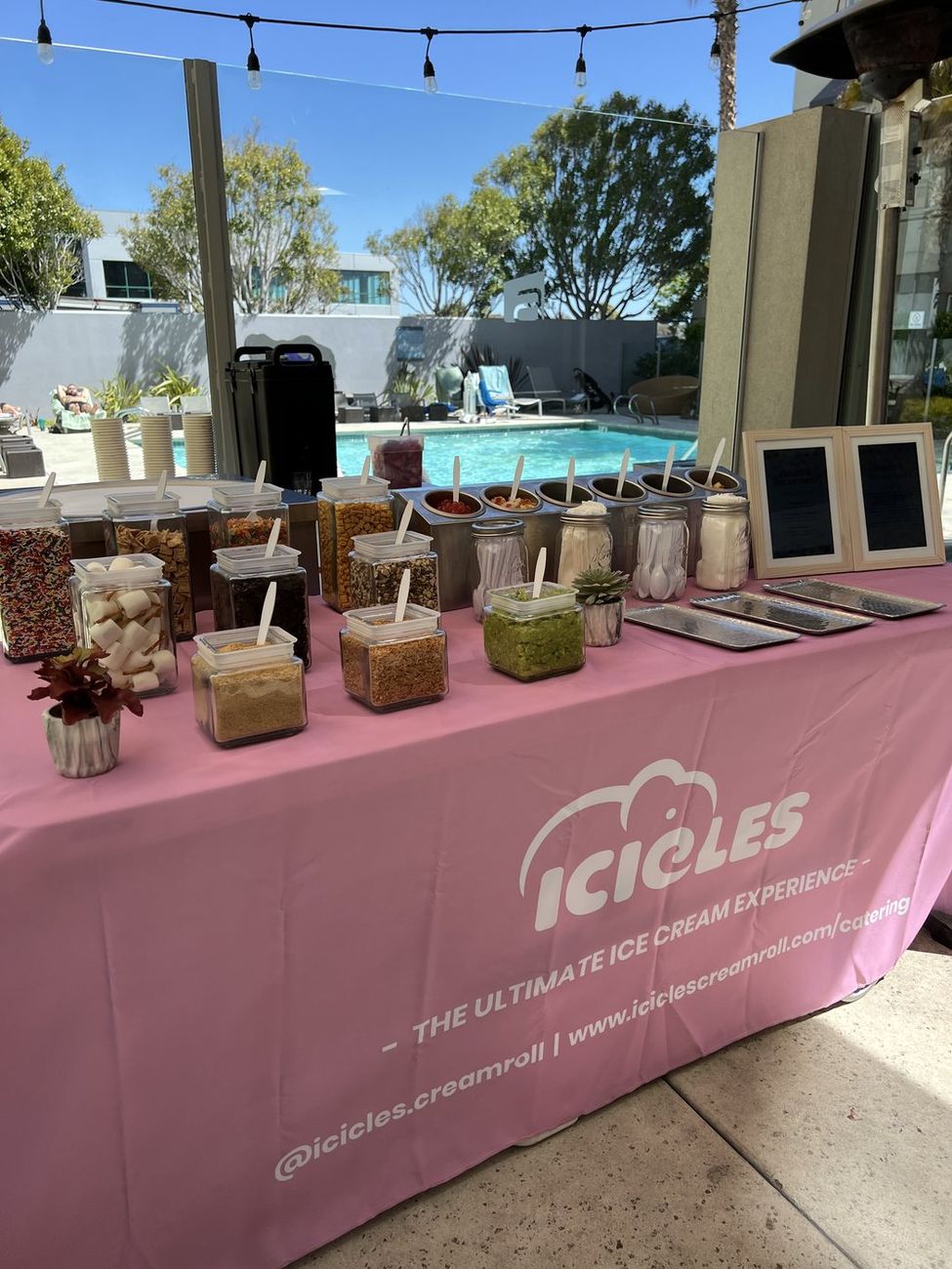 An Icicles team member rolling ice cream at a catered indoor event
