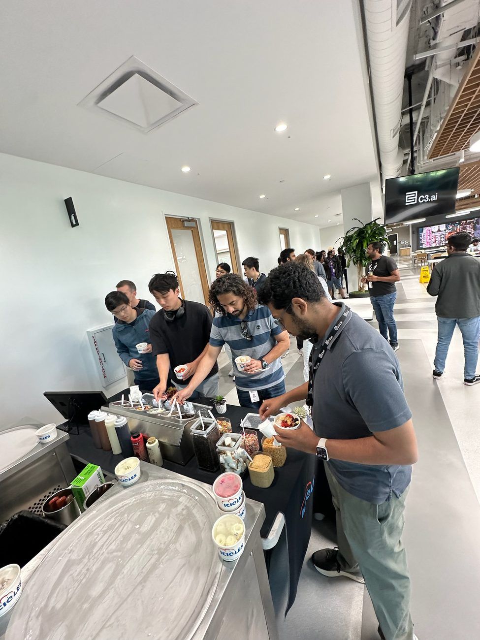 Employees building their own bowls at an Icicles station during a C3.ai company event
