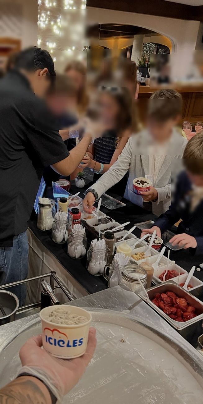 Young guests building their own bowls at the Icicles toppings bar at a celebration