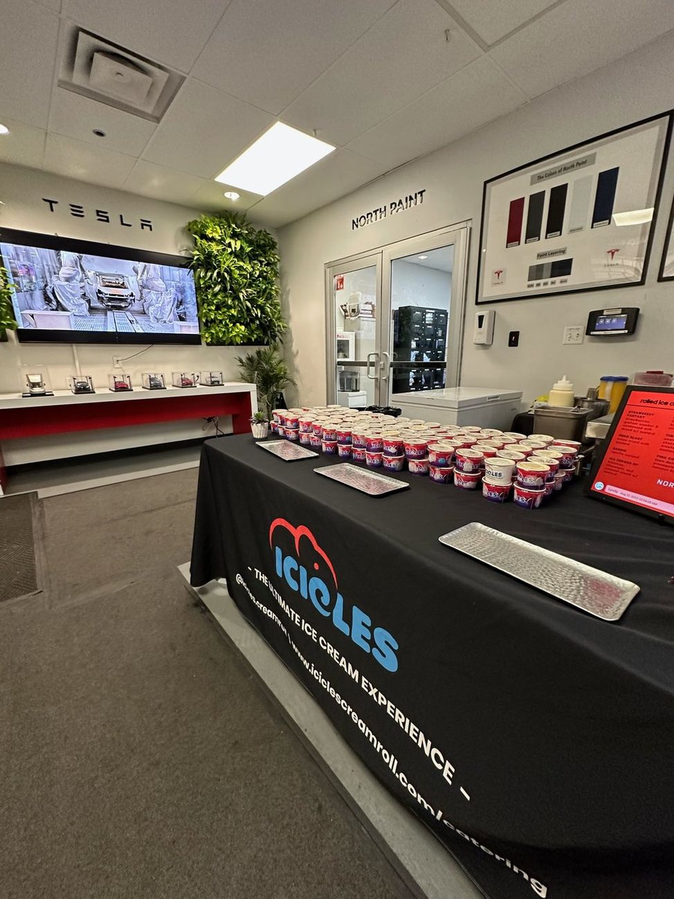An Icicles catering table set up inside a Tesla showroom